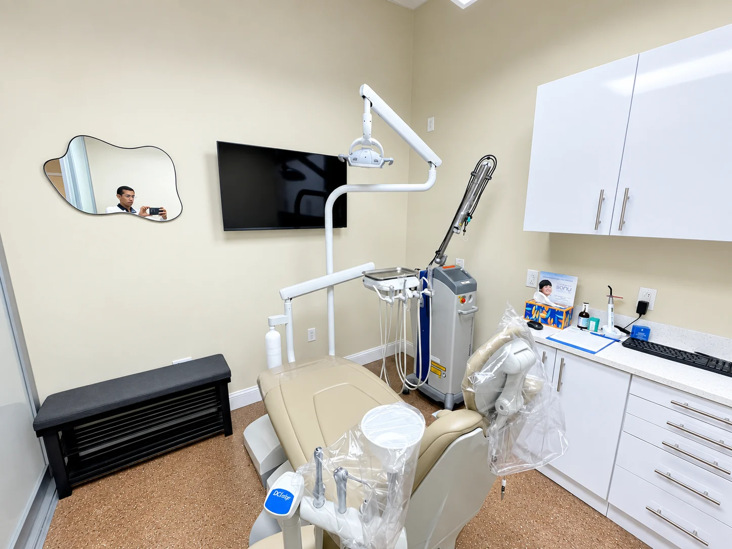 Treatment room with dental chair and laser